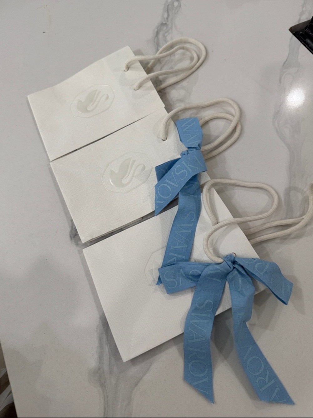 Swarovski White Paper bags with the signature Light Blue Ribbon